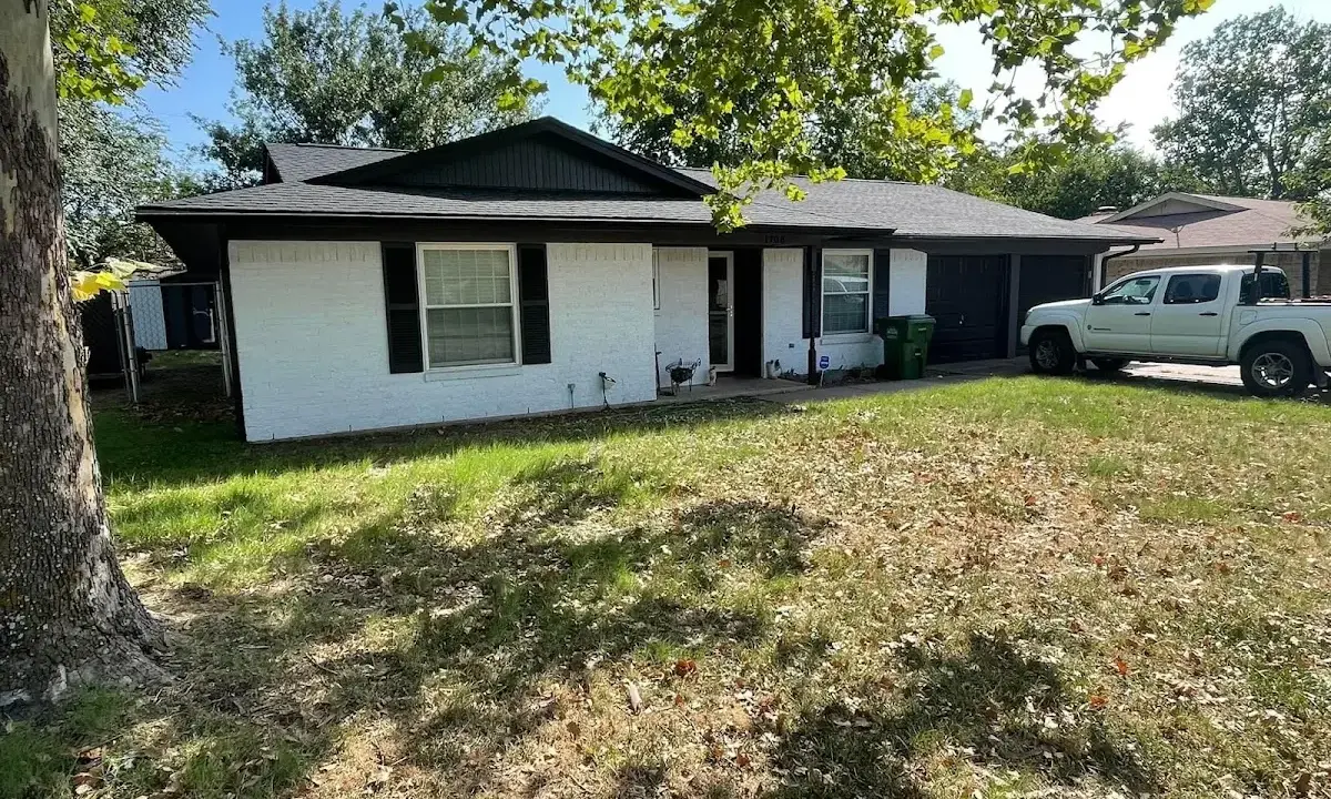 Professional roofing crew working on a residential roof in Rogers